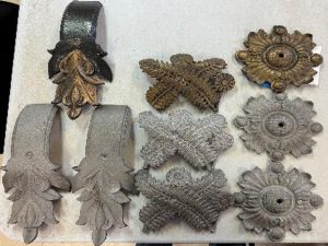 Replicated cast iron ornaments next to original painted ornaments to be placed in the Perry County Ohio Courthouse under reconstruction.