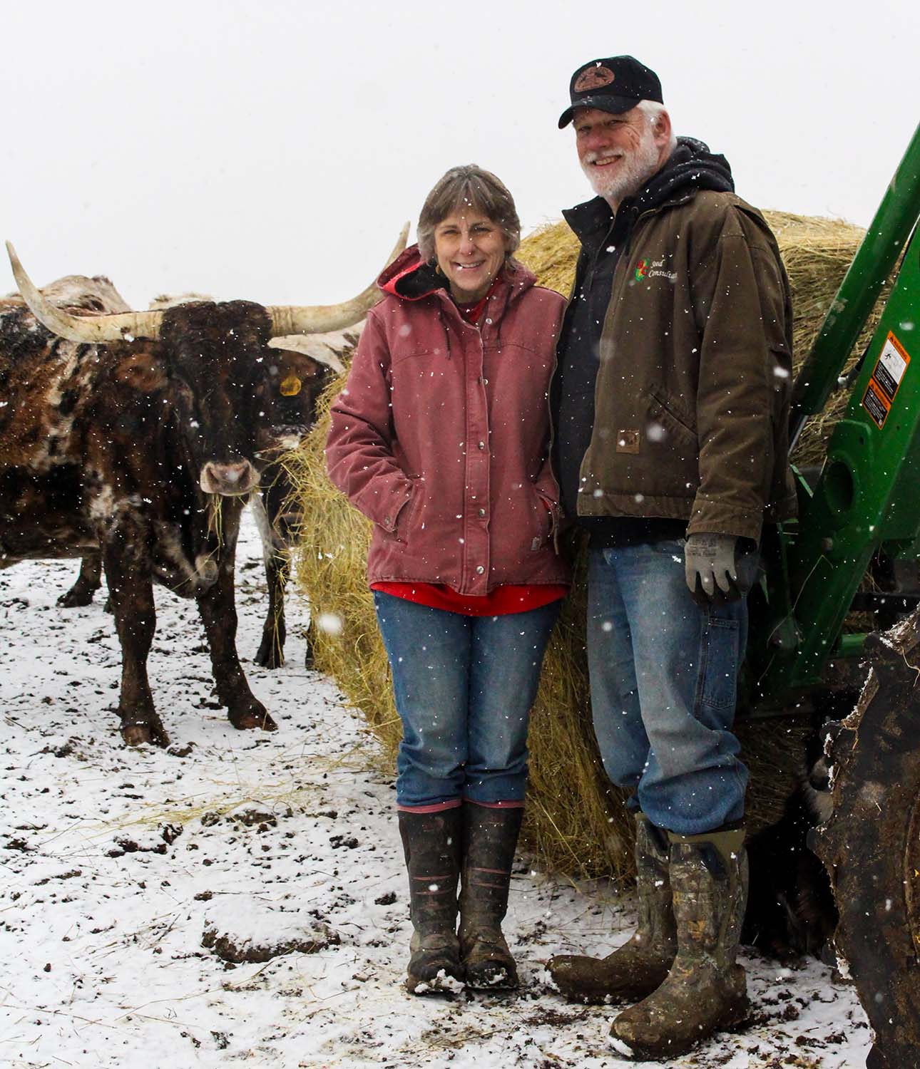 Perry County Commissioner Ben Carpenter and his wife Katrina on a winter day at their ranch with a Texas Longhorn steer.